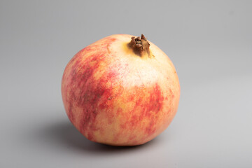 red pomegranate seeds on gray background