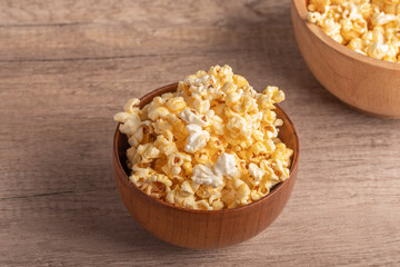 Popcorn in a wooden cup. Snacks.
