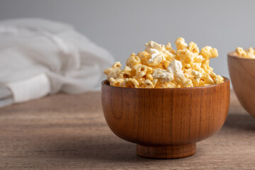 Popcorn in a wooden cup. Snacks.