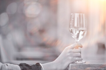 white wine glass in an outdoor cafe, spring view in a restaurant
