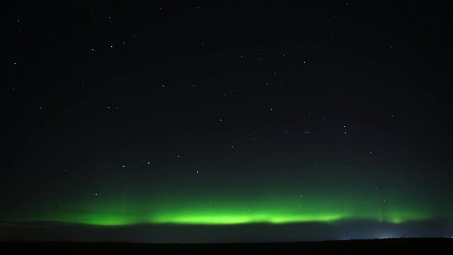 Time Lapse of Northern Lights (Aurora Borealis) appearing on the night sky full of stars. 