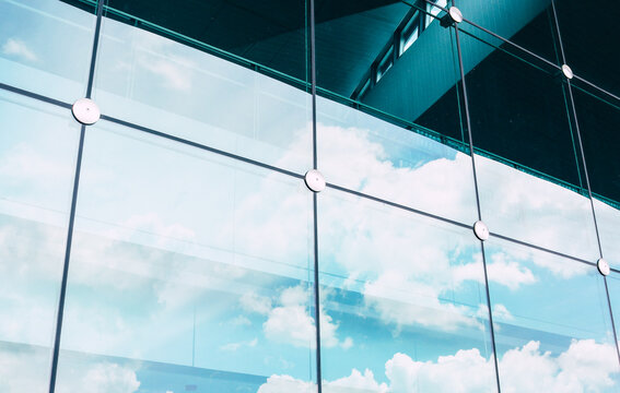 Laminated glass facade cable net system structure with spider fitting.