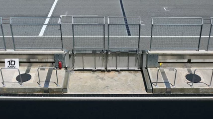 Fotobehang Steel wire mesh fence with service footpath in race track aerial top view. © Benjamin Salazar 