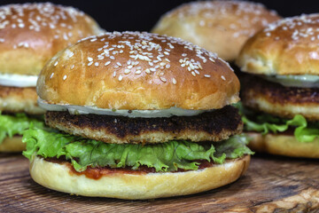Homemade burgers with chicken cutlet, lettuce, pickled onions, mayonnaise and ketchup.