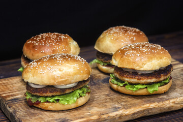 Homemade burgers with chicken cutlet, lettuce, pickled onions, mayonnaise and ketchup.