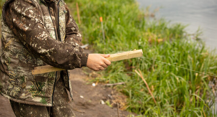 A fisherman on the river catches fish