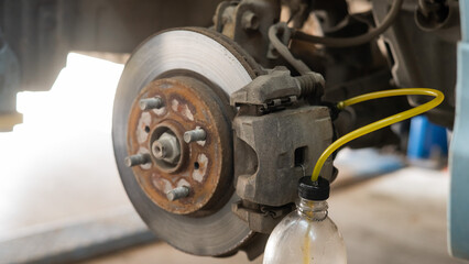Automatic change of brake fluid in a car service.  - obrazy, fototapety, plakaty