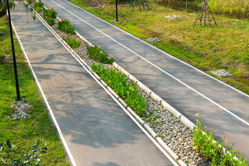 Aerial top view of road and bicycle lane in the natural park.