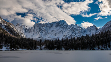 Fototapeta na wymiar Frozen lake of fusine in a sunny afternoon, Friuli-Venezia Giulia, Italy