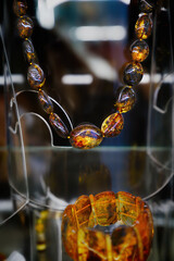 Amber beads on  a glass shelf