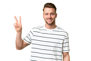 Young blonde caucasian man over isolated background smiling and showing victory sign