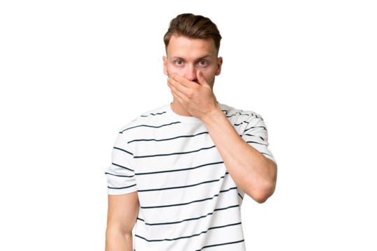 Young blonde caucasian man over isolated background covering mouth with hand