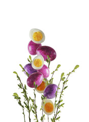 Isolated of falling Easter eggs with springtime branches with green leaves