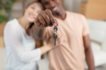 excited young family show keys to own home