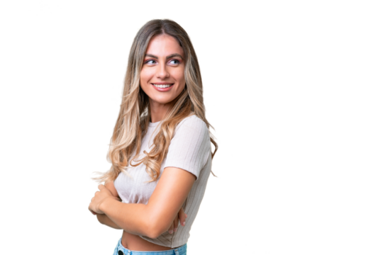 Young Uruguayan woman over isolated background with arms crossed and happy