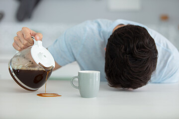 Fototapeta na wymiar sleepy man spill coffee at home