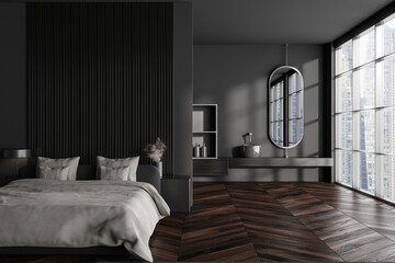 Front view on dark studio interior with bed, partition, mirror