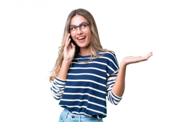 Young Uruguayan woman over isolated background keeping a conversation with the mobile phone with someone