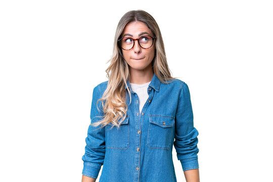 Young Uruguayan woman over isolated background having doubts while looking up