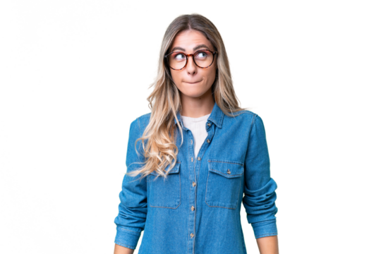 Young Uruguayan woman over isolated background having doubts while looking up