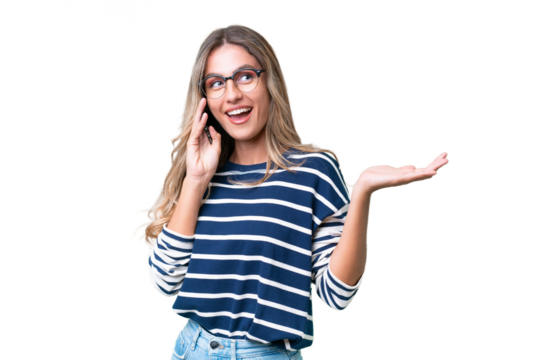 Young Uruguayan woman over isolated background keeping a conversation with the mobile phone with someone