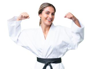 Young Uruguayan woman doing karate over isolated background doing strong gesture