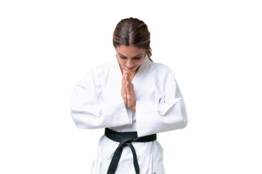 Young Uruguayan woman over isolated background doing karate and saluting