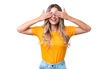 Young Uruguayan woman over isolated background covering eyes by hands and smiling