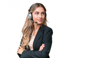 Telemarketer pretty Uruguayan woman working with a headset over isolated background with arms crossed and happy