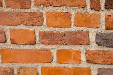 Obraz premium The background of the wall is made of red bricks. The texture of a building or structure.
