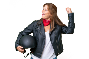 Middle-aged caucasian woman with a motorcycle helmet over isolated background celebrating a victory