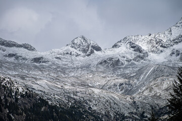 Fototapeta na wymiar Snow covered mountain peaks during the afternoon of a cold winter, Northern Italy
