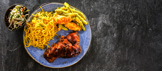 Chicken thighs in tamarind sauce with fried noodles and veggies