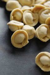 Fototapeta na wymiar Close-up of many handmade dumplings on a black background.