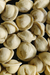 Close-up of many handmade dumplings.