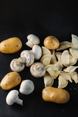 Dumplings with mushrooms and potatoes on a black background