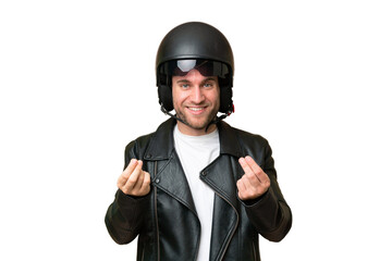 Young caucasian man with a motorcycle helmet isolated on green chroma background making money gesture