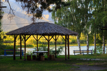 Lake in the mountains. Quiet bay in the greenery at sunset. Place for rest. Kyrgyzstan, Lake...
