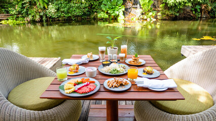 Colorful tropical breakfast on the table at resort outdoor restaurant