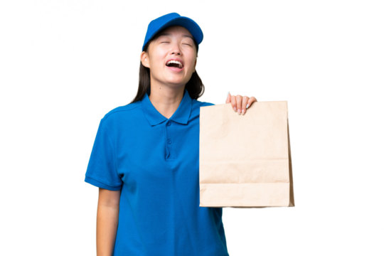Young Asian woman taking a bag of takeaway food over isolated background laughing