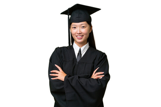 Young University Graduate Asian Woman Over Isolated Background Keeping The Arms Crossed In Frontal Position