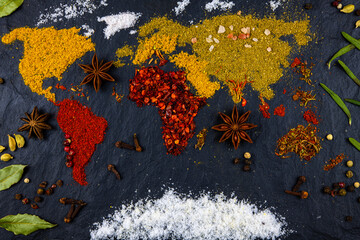 Map of the world of different spices and herbs on a black background.