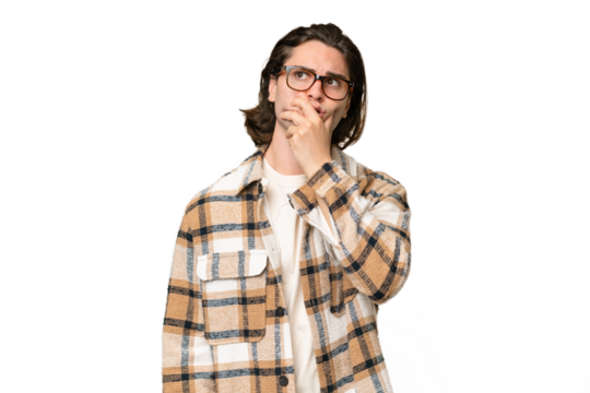 Young caucasian man isolated on green chroma background having doubts and with confuse face expression