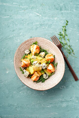 Salad with pear, avocado, shrimp, arugula and gorgonzola cheese. Italian diet salad, top view