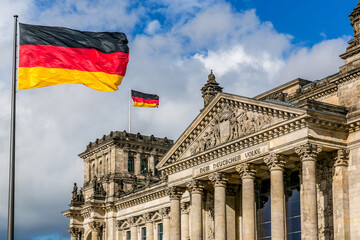 Naklejka premium The Reichstag building with German flags, Berlin, Germany
