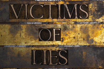 Victims of Lies on grunge textured copper and gold background