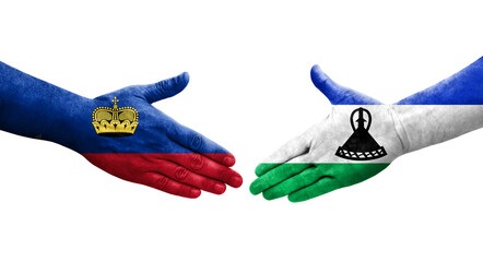 Handshake between Lesotho and Liechtenstein flags painted on hands, isolated transparent image.