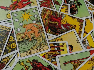 Picture of The Star tarot card from the original Ride Waite tarot deck with mixed tarot cards in the background