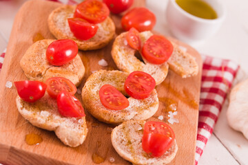 Friselle with cherry tomatoes and olive oil.