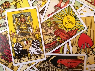 Picture of The Chariot tarot card from the original Rider Waite tarot deck with mixed tarot cards in the background